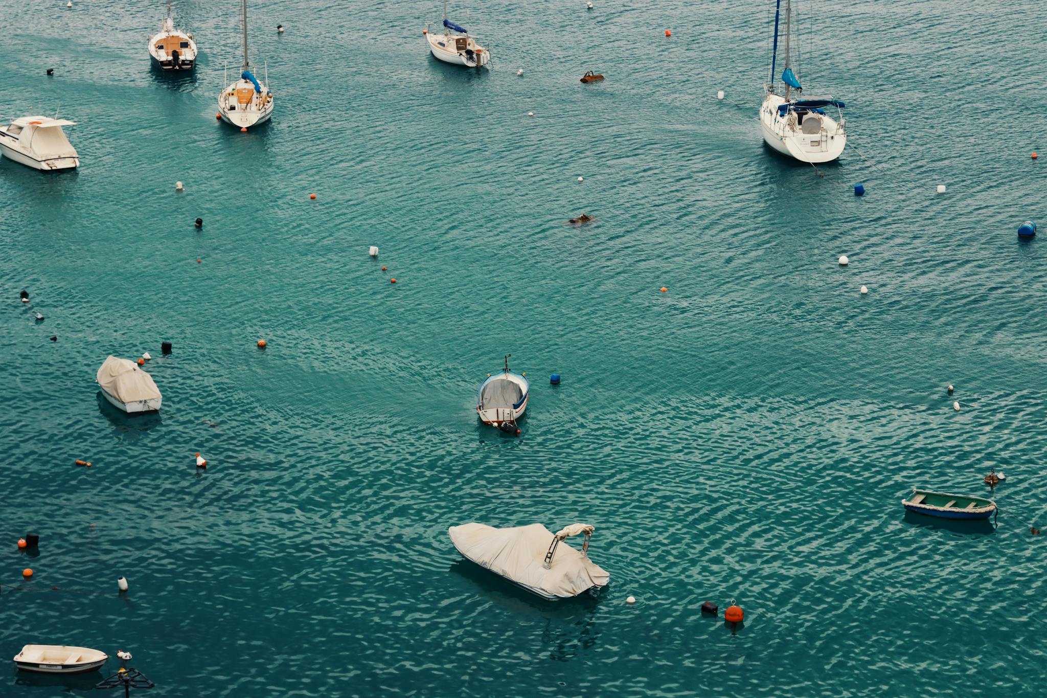 Peaceful view of boats floating in Valletta's turquoise waters, capturing leisure and travel vibes.