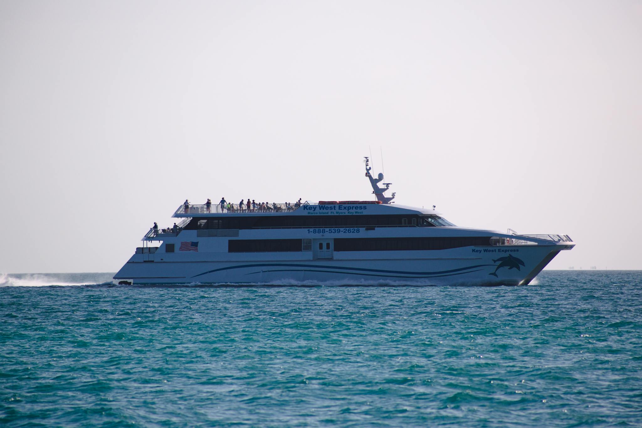 The Key West Express ferry traveling across calm ocean waters in a sunny setting.